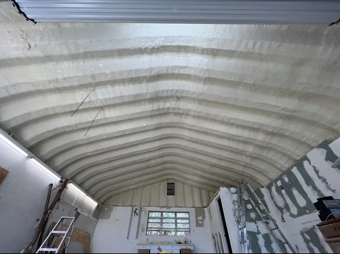 Spray polyurethane foam applied to the underside of a metal roof deck in Claiborne